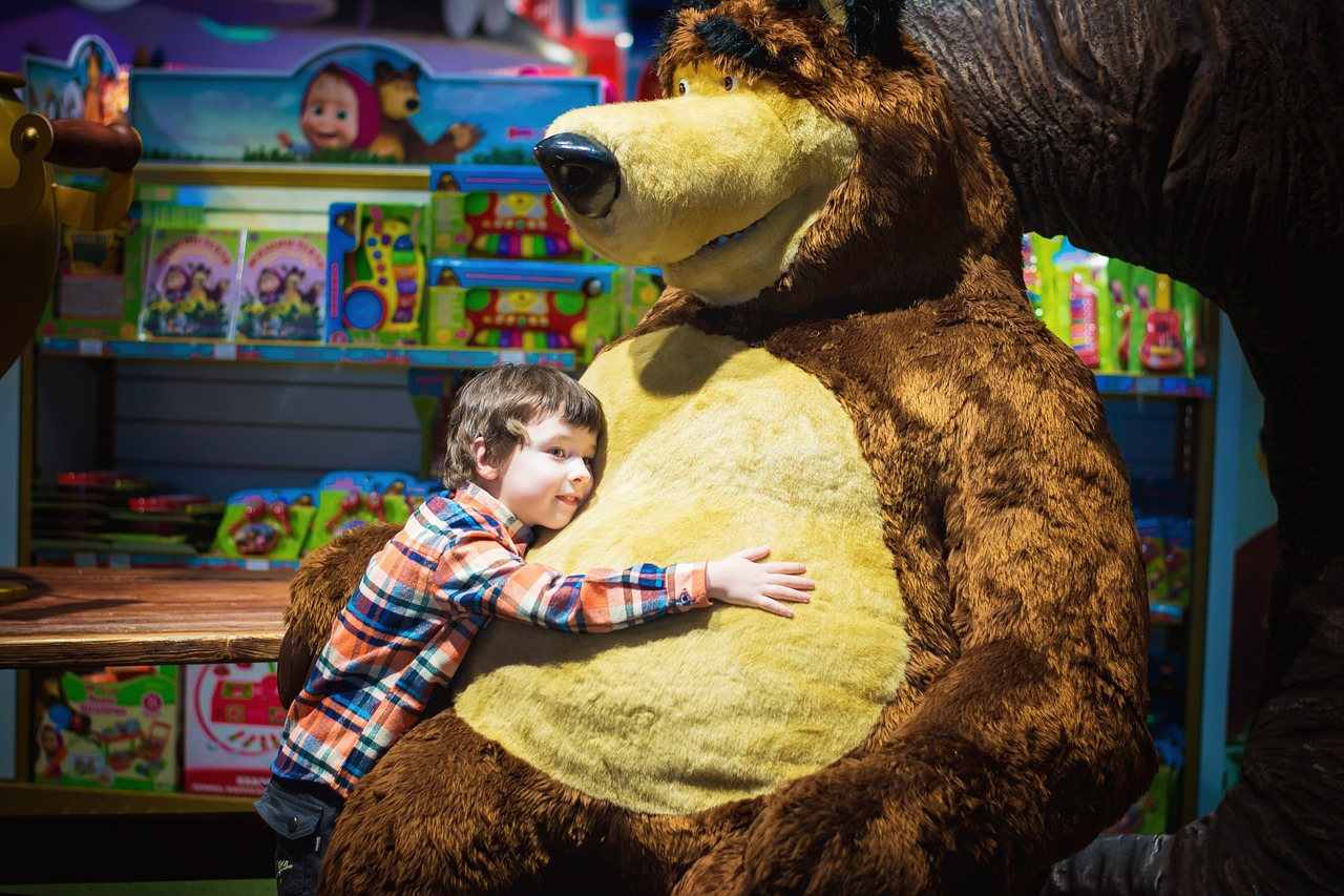 a boy with a large stuffed animal